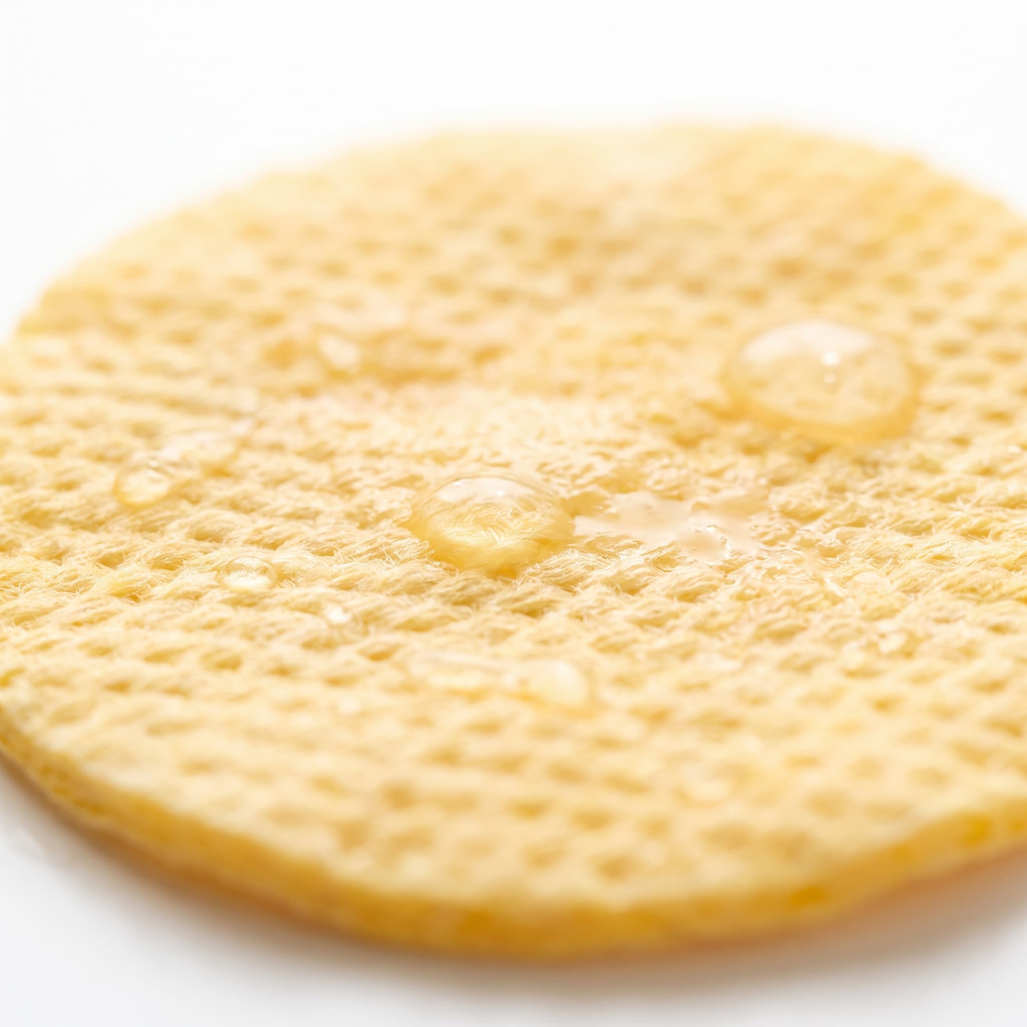 Close-up of a pre-soaked Veliena brightening pad and its textured surface